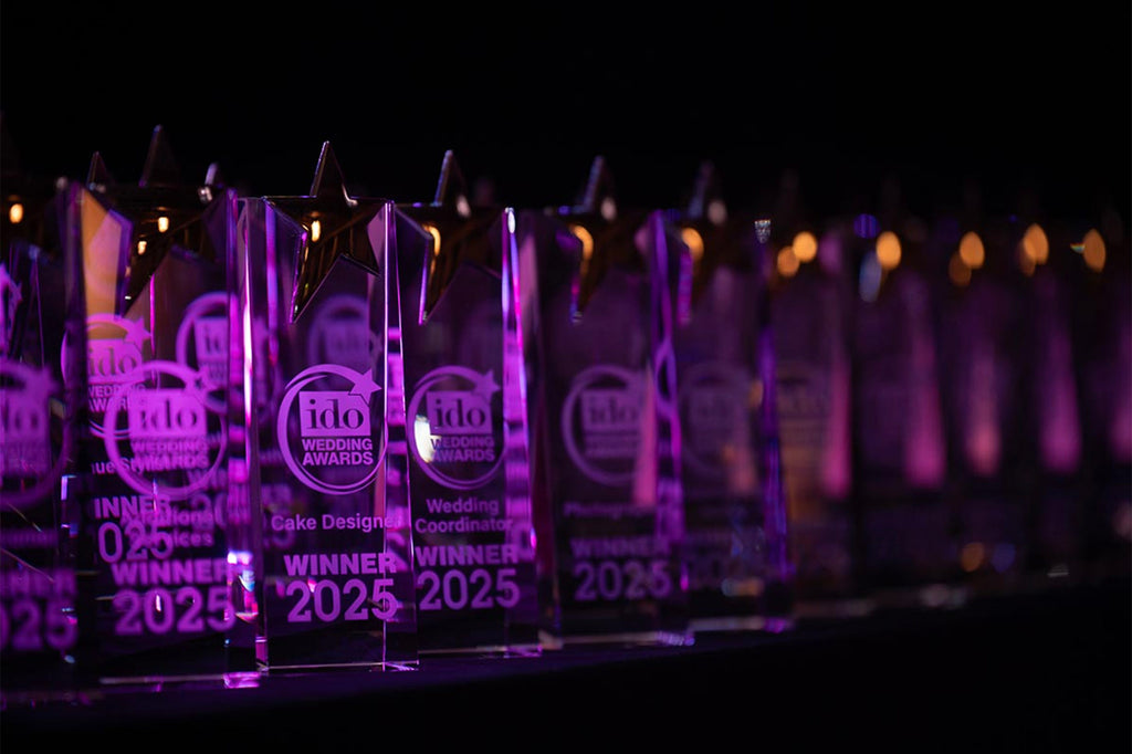 Row of glass awards with 'Winner 2025' text on a dark background